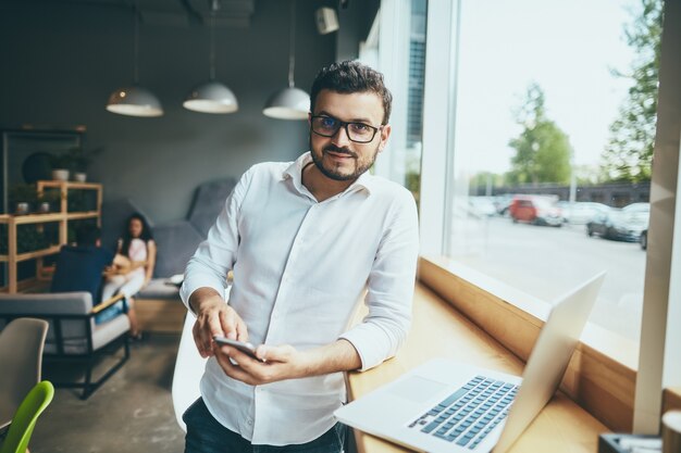 Attractive man working in cafe