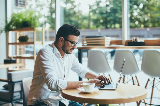 Attractive man working in cafe