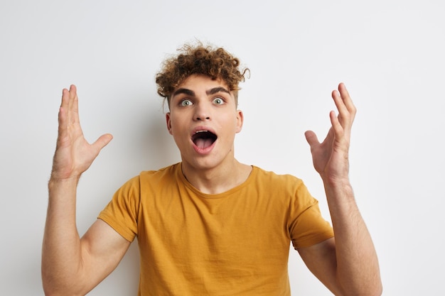 Attractive man in yellow tshirts gesture hands emotions Lifestyle unaltered