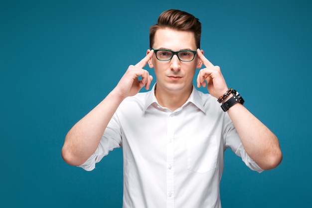 Attractive mature businessman in costly watch, black glasses and white shirt