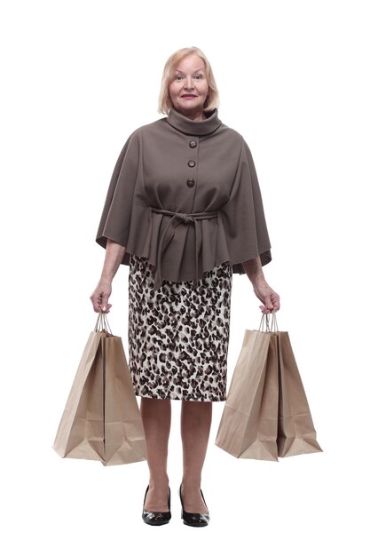 Attractive mature woman with shopping bags isolated on a white