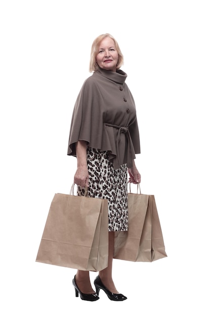 Attractive mature woman with shopping bags isolated on a white