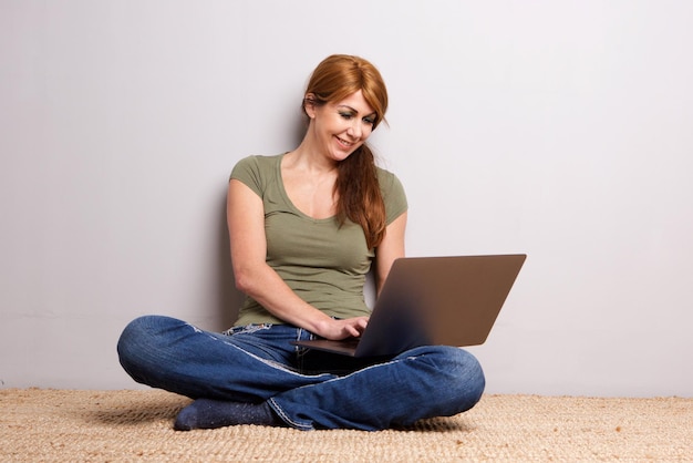 Attractive mature woman working on laptop