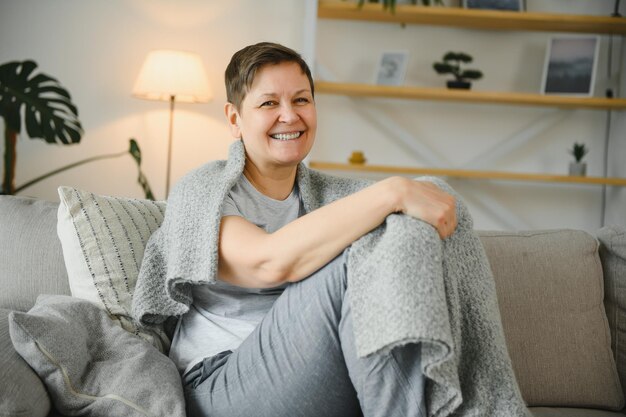 Attractive middle aged woman relaxing at home