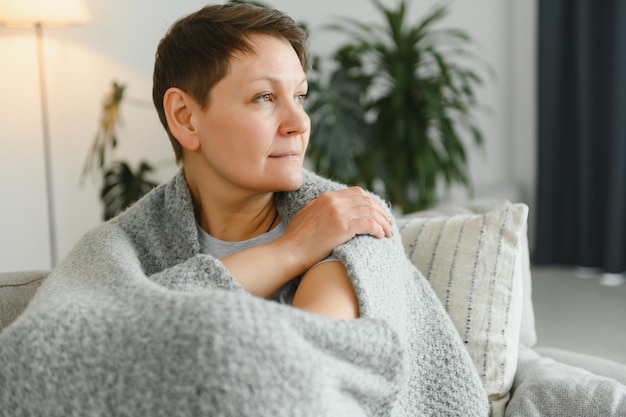 Attractive middle aged woman relaxing at home