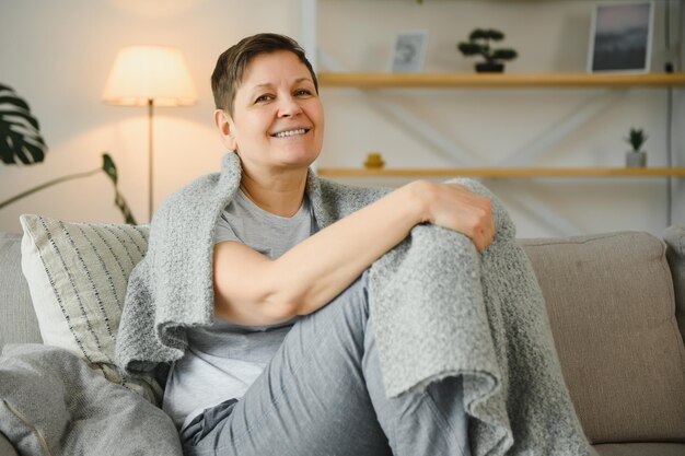 Attractive middle aged woman relaxing at home