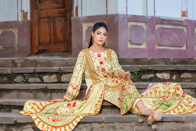 Attractive Model Girl Sitting on Stairs with Attitude Wearing Yellow Desi Dress at Ancient Place