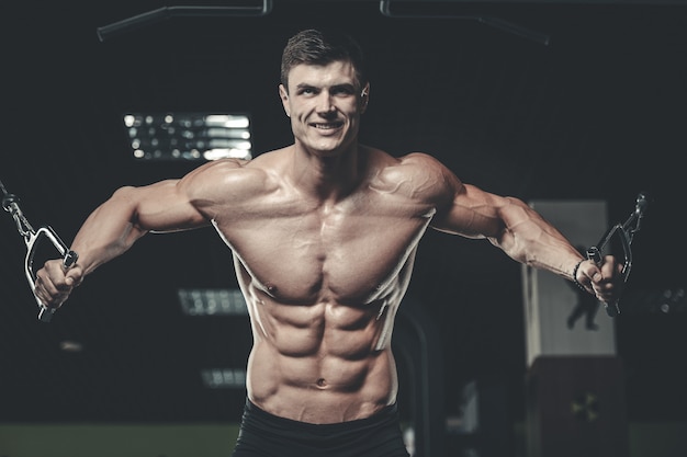 Attractive model young man training in gym