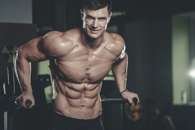 Attractive model young man training in gym