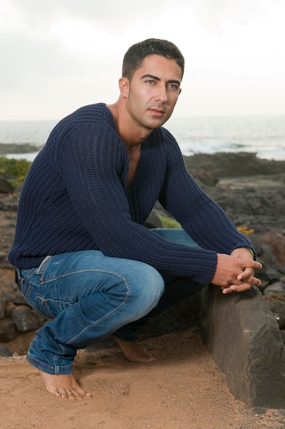 attractive and muscular man dressed casual in a seaside area