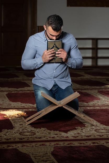 Attractive Muslim Guy Kissing The Koran