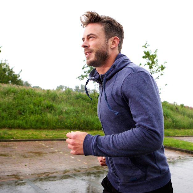 Attractive older male runner on street