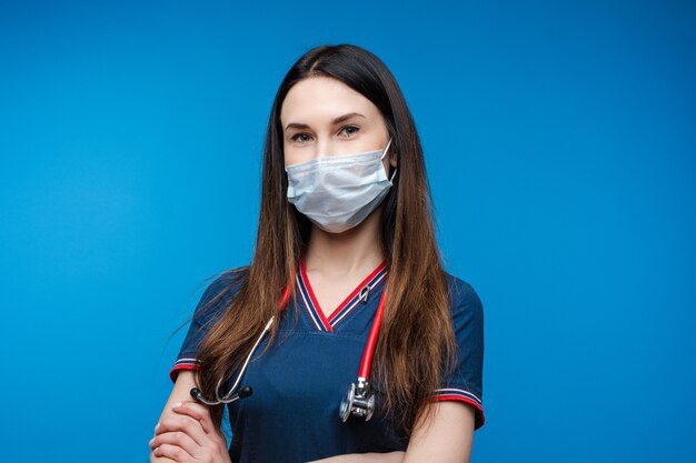 Attractive paramedic in face mask with stethoscope.