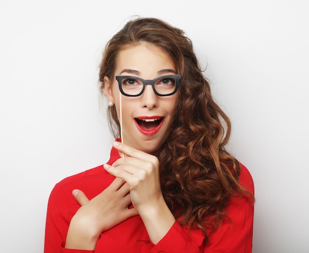 Attractive playful young woman with false glasses, ready for party