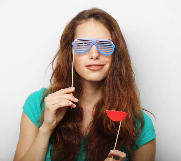 Attractive playful young woman with false glasses