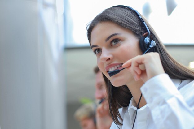 Attractive positive young businesspeople and colleagues in a call center office