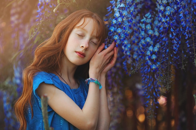 Attractive redhaired teen portrait Little girl with flowers