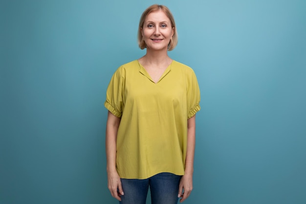 Attractive s blonde woman in yellow tshirt posing