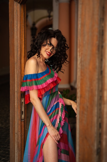 Attractive sensual woman wearing summer dress in the old city