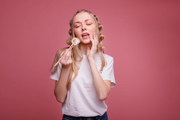 Attractive sexy woman with sushi. It's delicious.