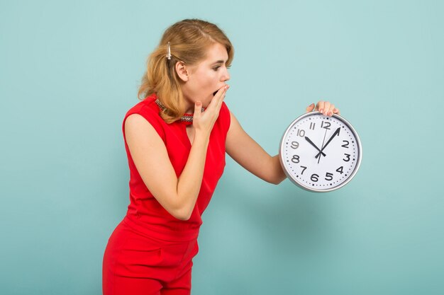 Attractive shocked woman with clocks