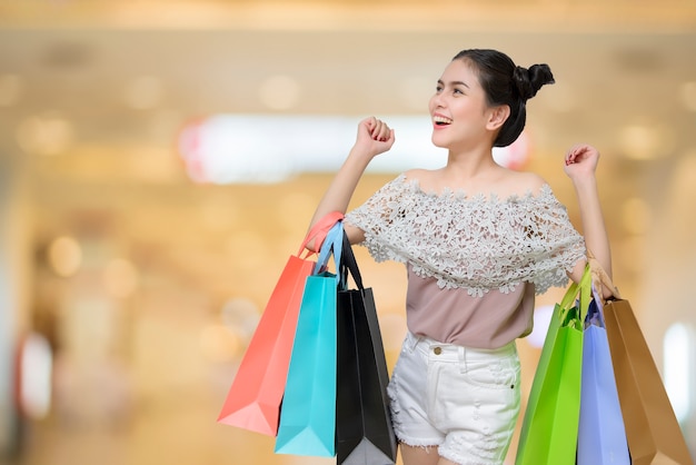 Attractive shopper woman holding shopping bags