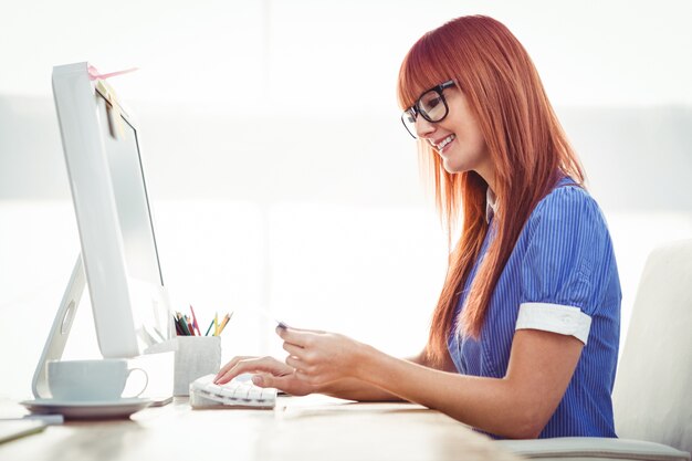 Posa attraente sorridente della donna dei pantaloni a vita bassa