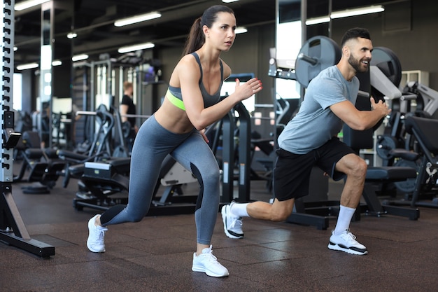 attractive sport couple doing fitness at gym.