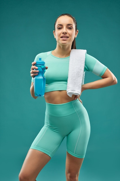 Attractive sporty woman holding bottle of water