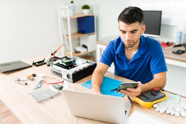 Attractive technician searching in the database to find a replacement part for an old damaged computer CPU