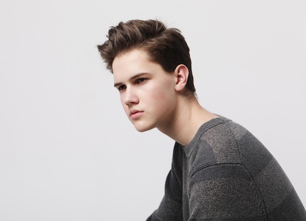 Attractive teenage boy posing in studio