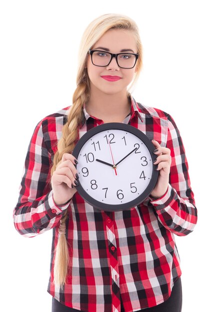 Attractive teenage girl in eyeglasses holding clock isolated on white background