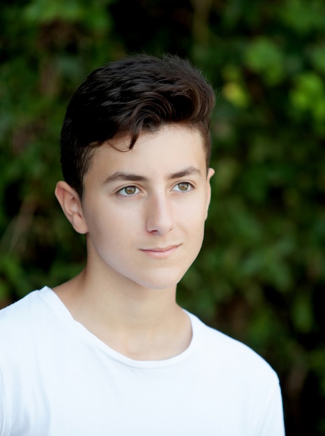 Attractive teenager guy in a park  