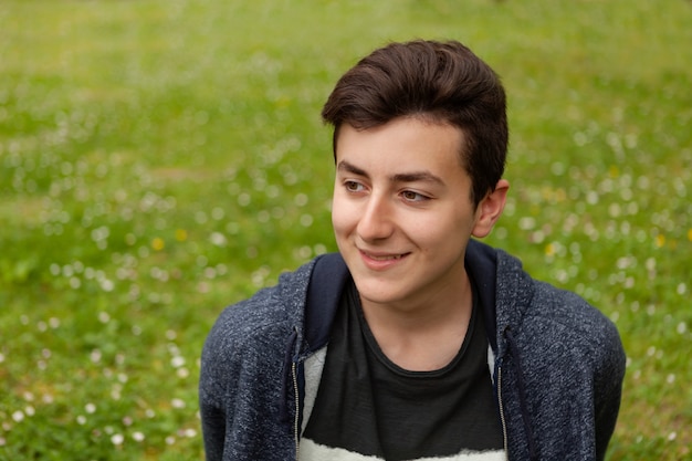 Attractive teenager guy in a park  