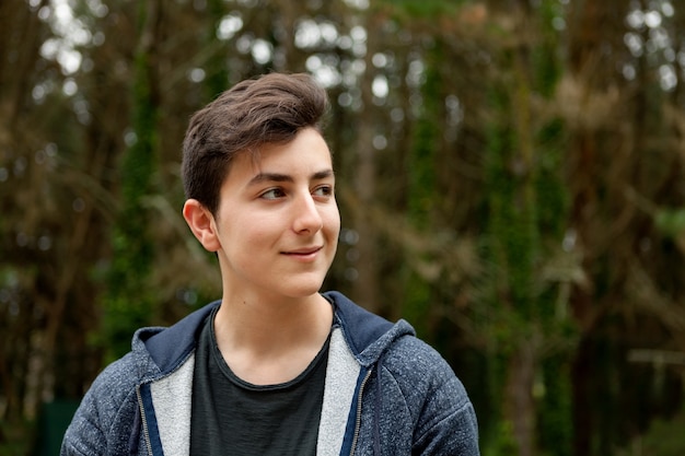 Attractive teenager guy in a park  