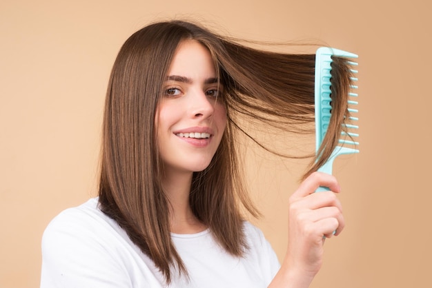 Attractive woman combing hair beautiful girl combs hair haircare concept