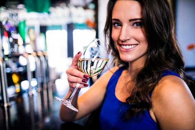 Attractive woman drinking wine in a bar