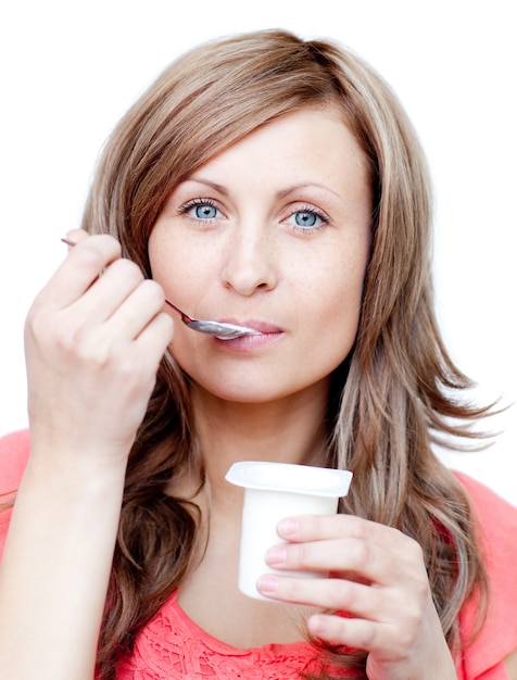 Attractive woman eating a yogurt 