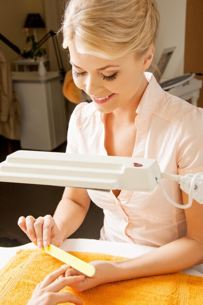 attractive woman having a manicure at the salon