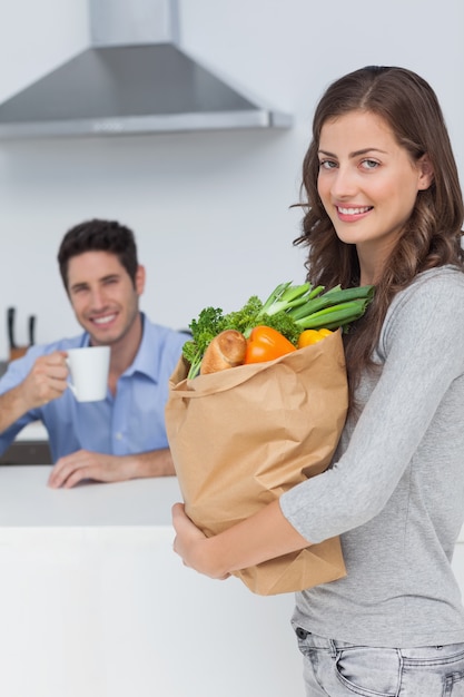 Attractive woman holding groceries bag 