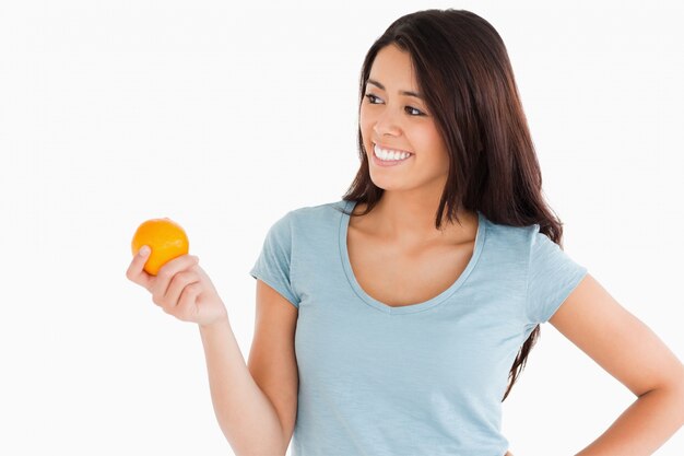 Attractive woman holding an orange