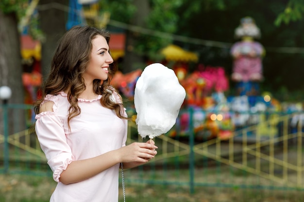 Attractive woman holding sweet cotton candy