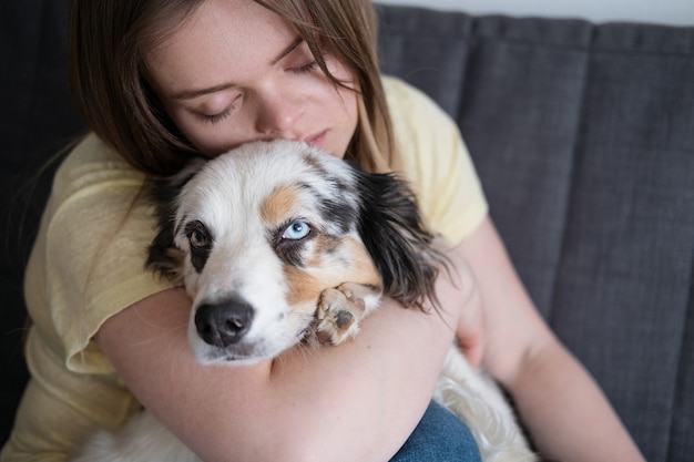 attractive woman hug embrace blue merle australian shepherd dog