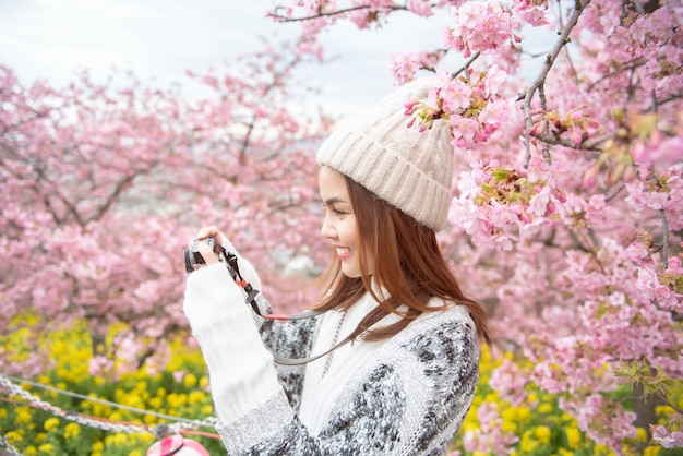Photo attractive woman is enjoying  with  cherry blossom in matsuda , japan