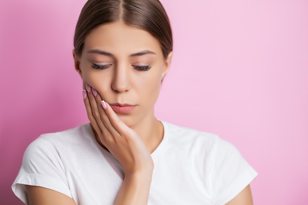 An attractive woman is experiencing a painful toothache