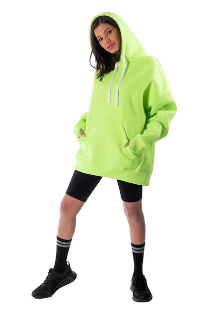 Attractive woman of Latin appearance wears a green hooded hoodie on a white background The girl looks sexy and happy The elegant brunette is wearing a dark sweatshirt Allseason clothing