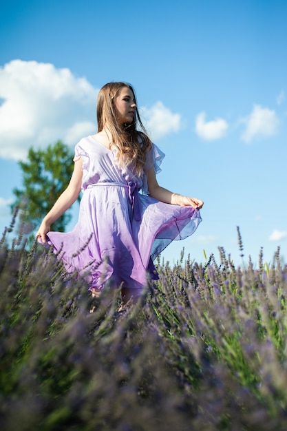 Attractive woman on the lavender field have fun