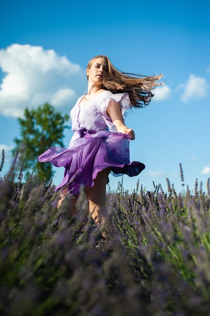 Attractive woman on the lavender field have fun