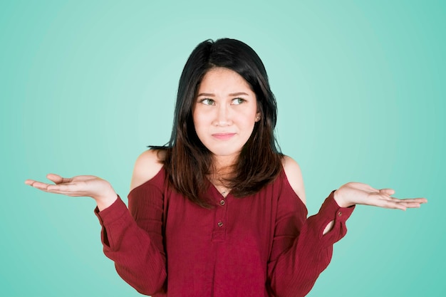 Attractive woman looks confused on studio