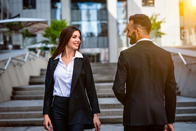 The attractive woman and man walking in the business center